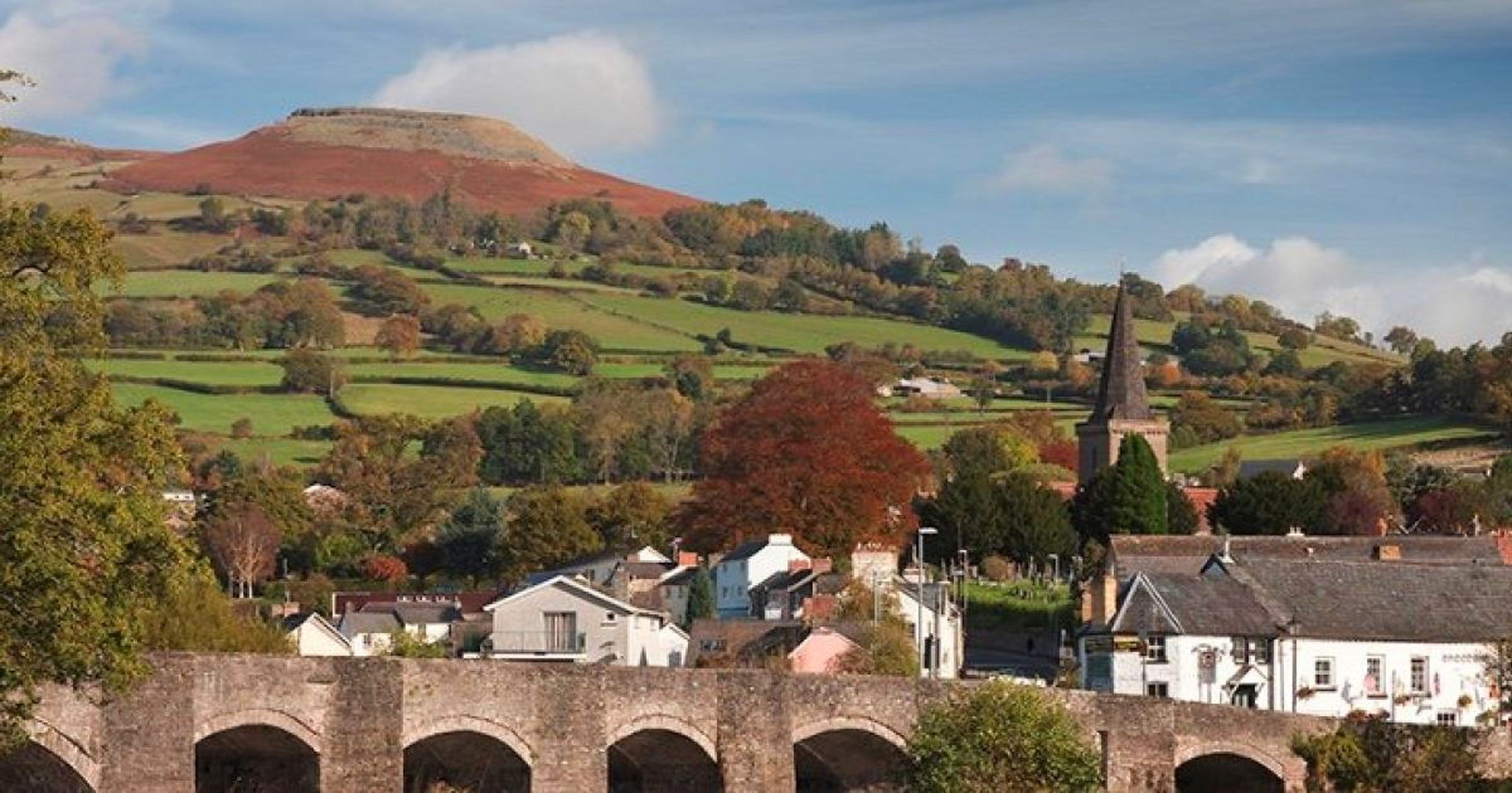 Table Mountain rising above Crickhowell with the stone bridge and church spire below