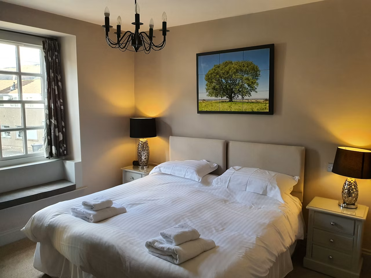 Spacious superior double/twin bedroom with chandelier, twin beds dressed in crisp white linen and a sunlit window seat